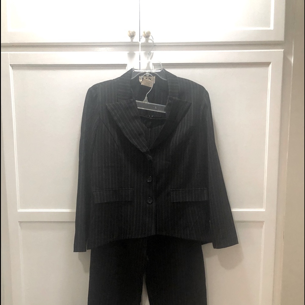 Gently worn, black pin striped suit, pants and jacket size 13/14.